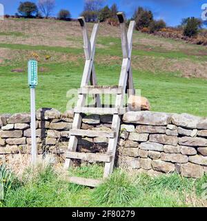 Public Footpath step stile over dry stonewall in the North Yorkshire Moors Stock Photo