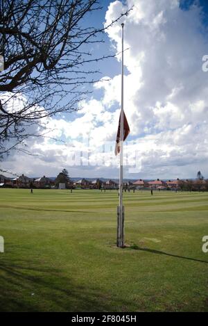 Newcastle upon Tyne, England, 10 April 2021. During a match the Benwell Hill Cricket Club flag flies at half mast in memory of HRH Prince Philip, Duke of Edinburgh who passed away the previous day. Credit: Colin Edwards/Alamy Live News. Stock Photo