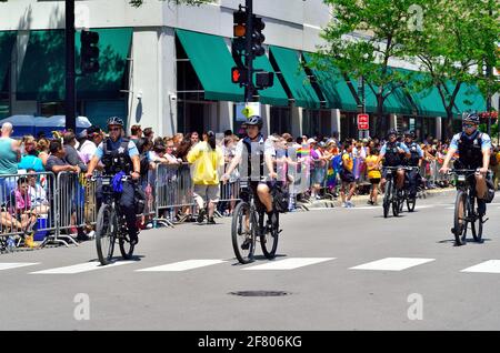 Chicago, Illinois, USA. Police officers mounted on bicycles ride along the parade route in advance of the start of the Chicago Pride Parade. Stock Photo