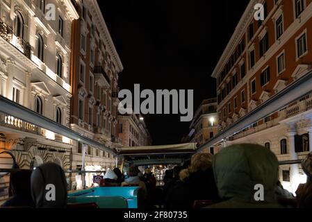 Rome, Italy. Spring 2020. Tourist bus on the streets of Rome. Tourists in a double-decker bus without a roof view the night Rome Stock Photo