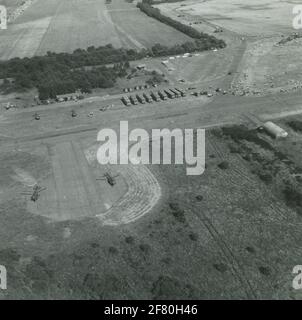 Aerial view taken by an RF-104G Starfighter During the air force Open days in the airbase. Clearly recognizable four Alouette III helicopters and 1 Piper Super Cub. Stock Photo
