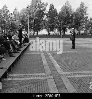 On the exercise area of the Van Ghentkazerne (VGKAZ) to the ROTAM, Kapitein der Mariniers (Kaptmarns) takes J.P. Laro the directive of the Marine Chapel of the Royal Netherlands Marine (Markap) about Van Kaptmarns H.C. Van Lijnschooten. The new conductor reports to the commander of the Marine corps (CKMARNS) General-Major der Mariniers (Genmajmarns) J.G.M. Nass. Stock Photo