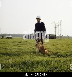 Masts of the Local Control Bunker (LCB) of the traffic line with a Korporaal-1 Air Force Monitoring (LB) with service dog along the runway on the TWENTHE airbase. Stock Photo