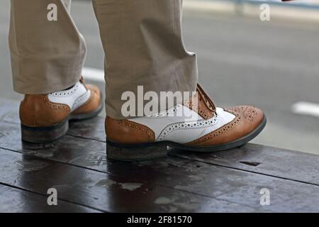 Close up of man wearing Two Tone Brogue shoes. Stock Photo