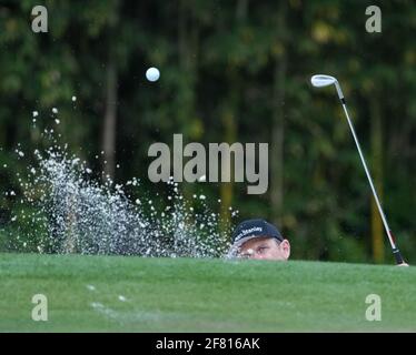 Justin Rose, of England, hits out of a bunker to the sixth green during ...