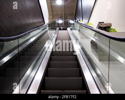 Electric stairs going up from a low angle indoor Stock Photo