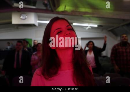 Woman with closed eyes of the Evangelical faith during evangelical event at the Evangelical Community South Zone in London , UK Stock Photo