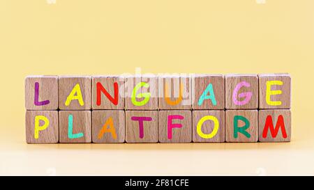 photo on language platform  theme. wooden cubes with the words "language platform", on light yellow background Stock Photo