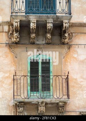 Modica Baroque balcony carvings Stock Photo