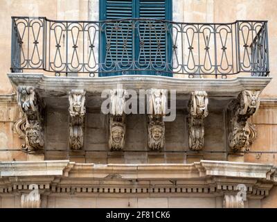 Modica Baroque balcony carvings Stock Photo