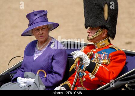 HRH The Queen with her husband and consort HRH Prince Philip, The Duke of Edinburgh at Trooping The Colour 17th June 2006. They ride together in horse drawn carriage across the parade ground. HRH The Queen shows a serious look. Stock Photo
