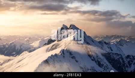 Aerial View from Airplane of Blue Snow Covered Canadian Mountain Landscape Stock Photo