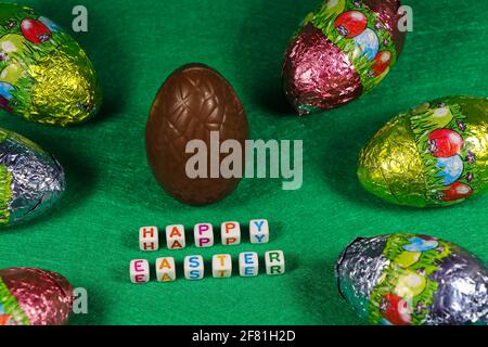 Happy Easter Chocolate Egg And Colorful Wrapped Eggs Stock Photo