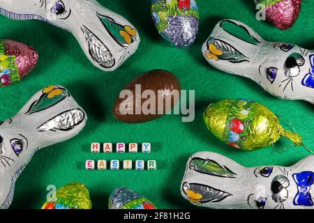 Happy Easter With Wrapped Chocolate Bunnies And Eggs Stock Photo