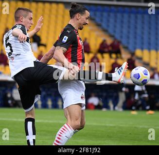 Parma, Italy. 10th Apr, 2021. AC Milan's Zlatan Ibrahimovic (R) vies with Parma's Andrea Conti during a Serie A football match between Parma and AC Milan in Parma, Italy, April 10, 2021. Credit: Alberto Lingria/Xinhua/Alamy Live News Stock Photo