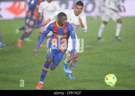 Madrid, Spain. 10th Apr, 2021. Real Madrid's Casemiro (back) vies with Barcelona's Ousmane Dembele during a Spanish league football match between Real Madrid and FC Barcelona in Madrid, Spain, on April 10, 2021. Credit: Edward F. Peters/Xinhua/Alamy Live News Stock Photo