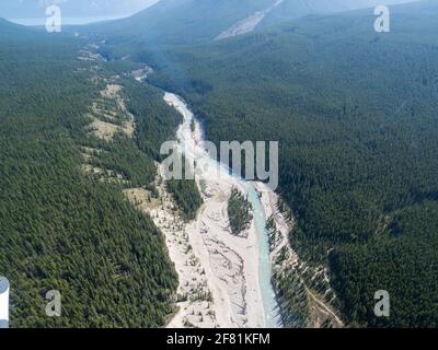 Aerial view of a forest in summer with a river in the middle Stock Photo