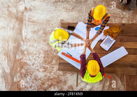 Top view of Team work construction hand coordination engineer and architects working meeting discussing designing planing measuring layout of building Stock Photo