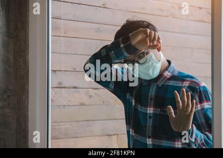 Asian man detain from society wear protective masks and unemployment at home Concept of economic crisis, people unemployment and production of Coronav Stock Photo