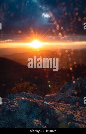 Rain illuminated by the setting sun fills the valley of Shenandoah National Park while spots of water speckled the lens of the camera. Stock Photo