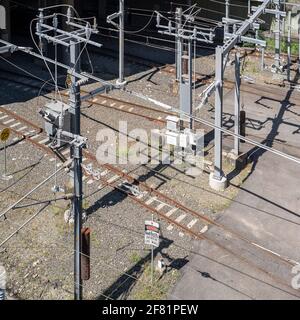 Railway infrastructure including tracks and overhead electrical wires Stock Photo
