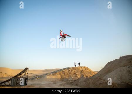 DUBAI, UNITED ARAB EMIRATES - Jan 30, 2021: Freestyle motorcross riders and motorbikes in the desert jumping of dunes Stock Photo