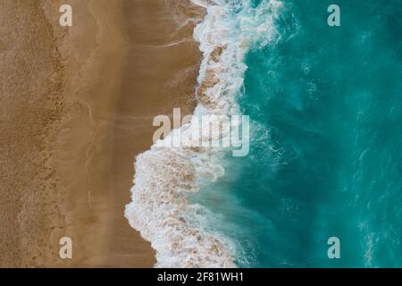 Blue sea wave on sandy beach. Sea shore top view Stock Photo