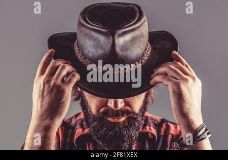 American cowboy. Leather Cowboy Hat. Portrait of young man wearing cowboy hat. Cowboys in hat. Handsome bearded macho. Man unshaven cowboys Stock Photo