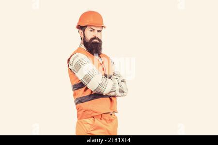 Builder in hard hat, foreman or repairman in the helmet. Man builders, industry. Worker in construction uniform. Architect builder. Bearded man worker Stock Photo