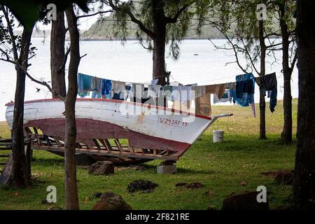 push boat on the ground, laundry drying outside on washing line, Mauritius island, Africa Stock Photo