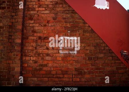 Square smiley graffiti on heritage listed brick wall Stock Photo