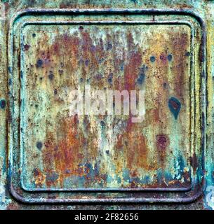 A heavily rusted metal plate with embossed lines around the edge Stock Photo
