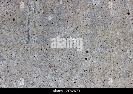 A flat grey concrete surface with lots of tiny air bubbles Stock Photo