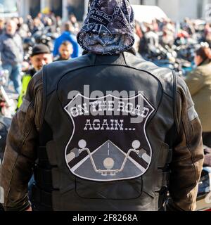Biker wearing leather jacket with On The Road Again emblem at the annual motorcycle bike fest gathering and parade for bikers in Sofia, Bulgaria Stock Photo