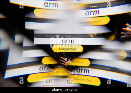 Milan, Italy - APRIL 10, 2021: ARM Holdings logo on laptop screen seen through an optical prism, creative interpretation. Dynamic and unique image fro Stock Photo
