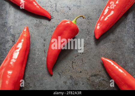 Bright red sweet peppers on dark baking sheet. Flat lay, free space for text Stock Photo