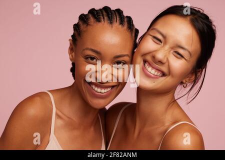 Portrait of a cheerful young women looking at camera and smiling.  Natural Beauties with fresh and clean skin Stock Photo