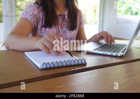 Female remotely working, studying online. Stock Photo