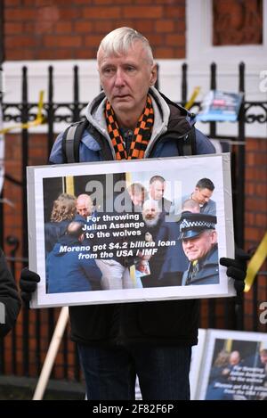 London, UK. 11 Apr 2021. Protester holding a sign outside Ecuadorian Embassy to raise awareness of 2 years anniversary since Julian Assange was arrested. Credit: Andrea Domeniconi/Alamy Live News Stock Photo