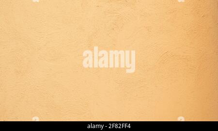 Yellow orange Beige painted stucco wall construction. Pattern Background texture. Stock Photo