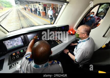 Kota Bharu, Malaysia's northern Kelantan state. 11th Apr, 2021. Malaysian Transport Minister Wee Ka Siong (R) takes a ride on the Diesel Multiple Unit train in Kota Bharu, the capital of Malaysia's northern Kelantan state, April 11, 2021. The Diesel Multiple Unit (DMU) trains manufactured by China Railway Rolling Stock Corporation (CRRC) Zhuzhou Electric Locomotive Co., Ltd were launched into operations on Sunday, which will boost connectivity and facilitate travel in Malaysia's eastern coast area. Credit: Zhu Wei/Xinhua/Alamy Live News Stock Photo