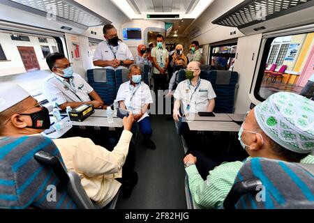 Kota Bharu, Malaysia's northern Kelantan state. 11th Apr, 2021. Malaysian Transport Minister Wee Ka Siong (Central R) takes a ride on the Diesel Multiple Unit train in Kota Bharu, the capital of Malaysia's northern Kelantan state, April 11, 2021. The Diesel Multiple Unit (DMU) trains manufactured by China Railway Rolling Stock Corporation (CRRC) Zhuzhou Electric Locomotive Co., Ltd were launched into operations on Sunday, which will boost connectivity and facilitate travel in Malaysia's eastern coast area. Credit: Zhu Wei/Xinhua/Alamy Live News Stock Photo