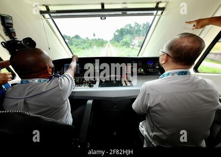 Kota Bharu, Malaysia's northern Kelantan state. 11th Apr, 2021. Malaysian Transport Minister Wee Ka Siong (R) takes a ride on the Diesel Multiple Unit train in Kota Bharu, the capital of Malaysia's northern Kelantan state, April 11, 2021. The Diesel Multiple Unit (DMU) trains manufactured by China Railway Rolling Stock Corporation (CRRC) Zhuzhou Electric Locomotive Co., Ltd were launched into operations on Sunday, which will boost connectivity and facilitate travel in Malaysia's eastern coast area. Credit: Zhu Wei/Xinhua/Alamy Live News Stock Photo