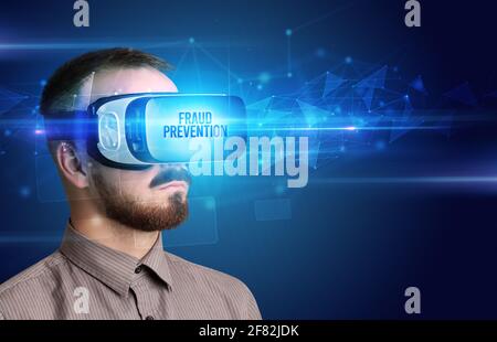 Businessman looking through Virtual Reality glasses, virtual security concept Stock Photo