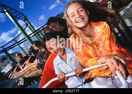 Young girls on a mini roller coaster ride, Adventure Island. Southend-on-Sea. Essex. England. UK. Stock Photo