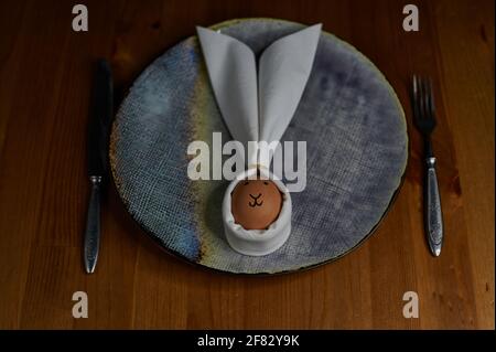 bunny made of napkins and eggs with table set, view from above Stock Photo