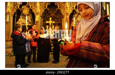 Children from St Barnabas Church of England school, Pimlico, getting ready to take part in the Childrens Societys annual Christingle celebrations at Westminster Abbey. This years theme is shine a Light on BullyingThe Orange symbolises the world,the red ribbon the blood of Christ and the candle the light of the world. pic David Sandison 28/11/2002 Stock Photo