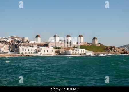 Panoramic view from the sea of the windmills on the island of Mykonos in Greece, Cyclades Islands. Tourism travel concept Stock Photo