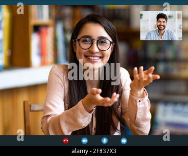 Remote distant communication concept. Happy woman having video call or online lesson, talking with arab man Stock Photo