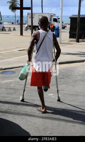 salvador, bahia, brazil - february 4, 2021: man with amputated leg using crutches in the Itapua neighborhood in the city of Salvador. *** Local Captio Stock Photo